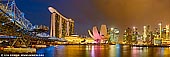 singapore stock photography | Singapore Downtown Panorama at Night, Marina Bay, Singapore, Image ID SINGAPORE-0008. Panoramic image of the Marina Bay Sands Hotel, Helix Bridge, ArtScience Museum and Singapore Downtown at Night. The Marina Bay at Singapore is an awesome sight, especially at night. Filled with skyscrapers and historic monuments, there are plenty of attractions to see. In olden days, the Marina bay was devoid of commercial buildings and traffic and was a perfect place to enjoy the sea breeze and exchange gossips. Story tellers and book enthusiasts often met here and talked about their stories or their recent studies. Today, the Marina Bay is known around the world for its extraordinary skyline view. The Singapore downtown, often known as 'downtown core' by locals is the area around Marina Bay. With bronze sculptures, historical monuments, parks and interesting activities, it is quite a fun place. Walking on the bridges while enjoying the beauty of the land and water is a popular activity among Singaporeans.