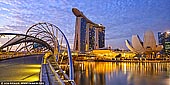  stock photography | Marina Bay Sands Hotel and Helix Bridge at Sunrise, Marina Bay, Singapore, Image ID SINGAPORE-0006. The Helix Bridge, previously known as the Double Helix Bridge, is a pedestrian bridge linking Marina Centre with Marina South in the Marina Bay area in Singapore. The Helix Bridge is set to become Singapore's next landmark. Located beside the Benjamin Sheares Bridge, alongside the vehicular Bayfront Bridge, it was officially opened on 24 April 2010 and is the world's first curved bridge. The views of the harbor and some of the city's great buildings are wonderful. A night visit is preferable to see the lights and the magnificent view.