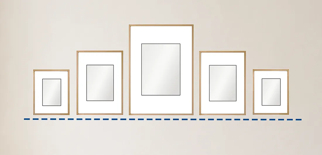 Hanging pictures in a row so that the base lines of all pictures line up. This works with both regular and irregular frame shapes.