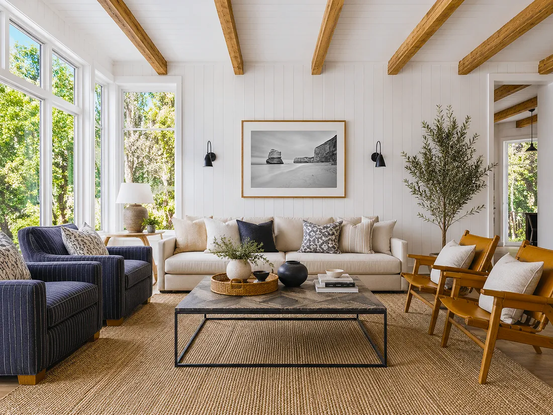 Modern Australian coastal living room with exposed timber beams, neutral sofa, natural textures and black and white coastal wall art above the couch