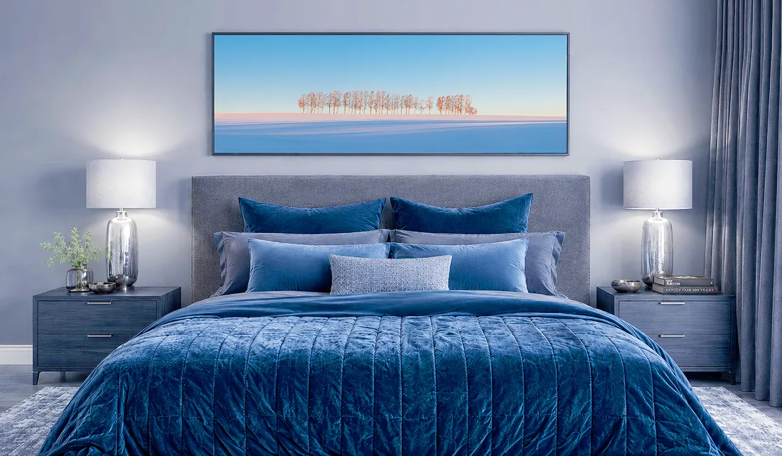 Bedroom with a large horizontal landscape photograph hung above the bed, showing how wide artwork can connect visually with the bedhead.