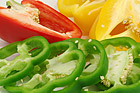 Sliced red, yellow and green sweet bell peppers.